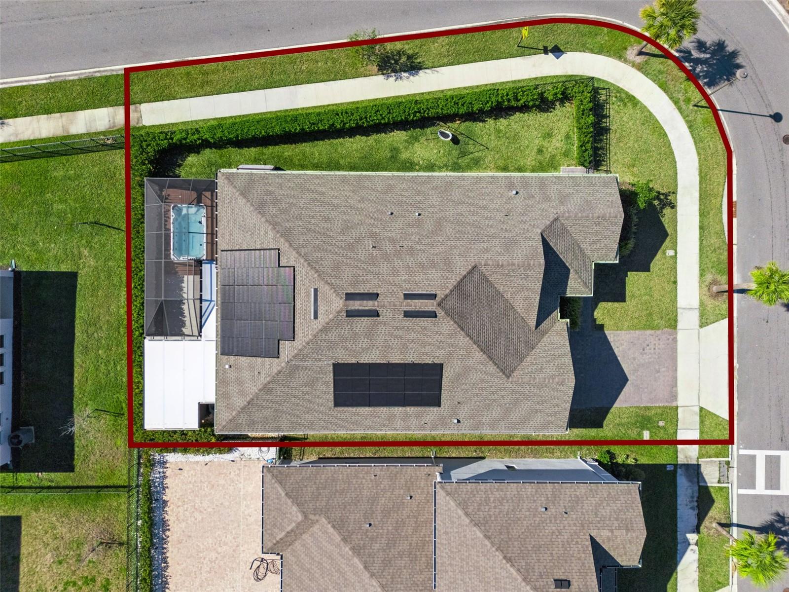 Aerial view showcasing the home, lot, and surrounding neighborhood.
