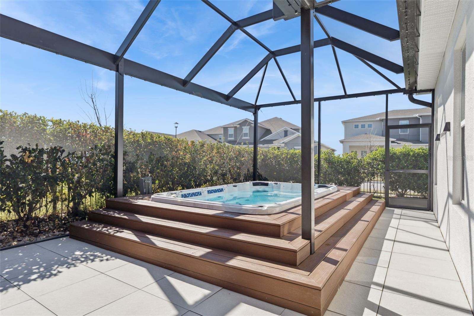 Spacious screened patio overlooking the private backyard area.