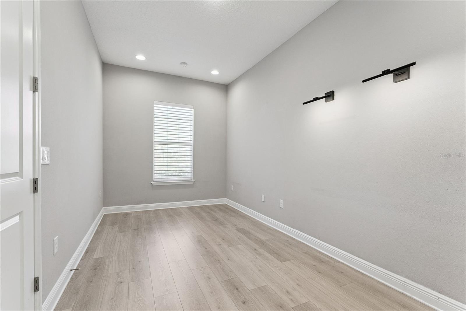 Versatile office/den with natural light and ample space.