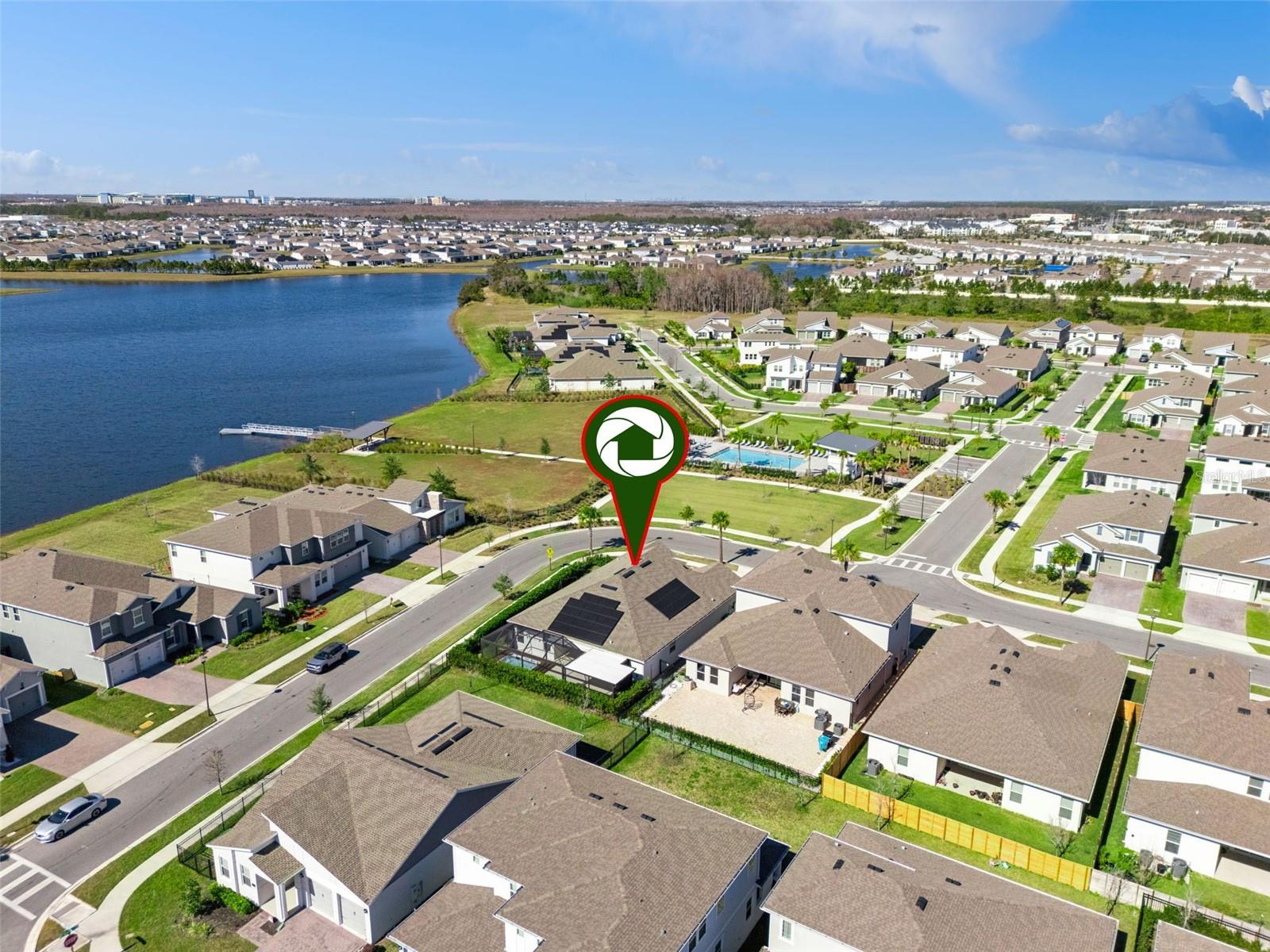 Aerial view showing the communitys scenic surroundings and nearby water views.