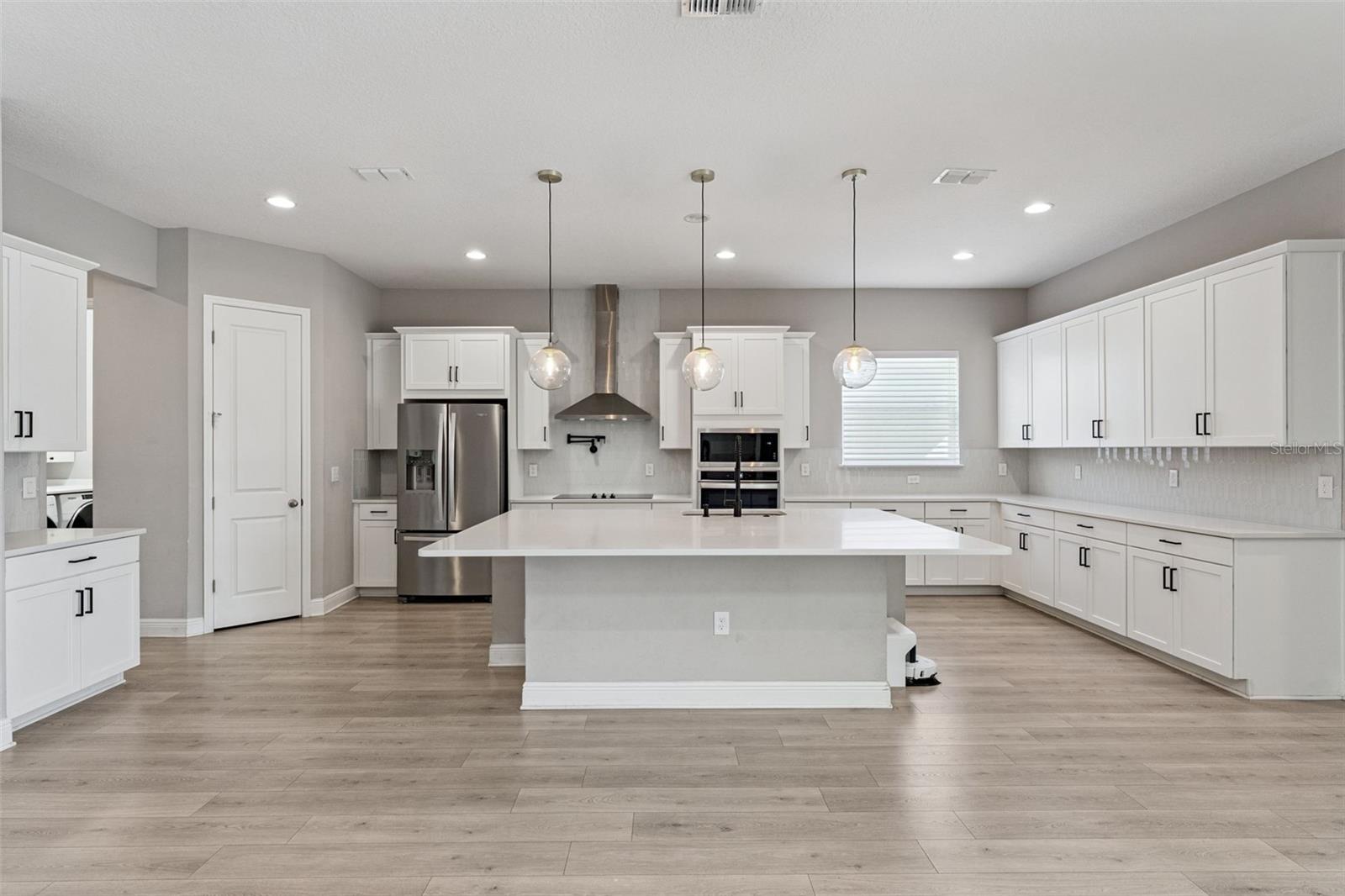 Bright kitchen featuring a large island and open-concept layout.