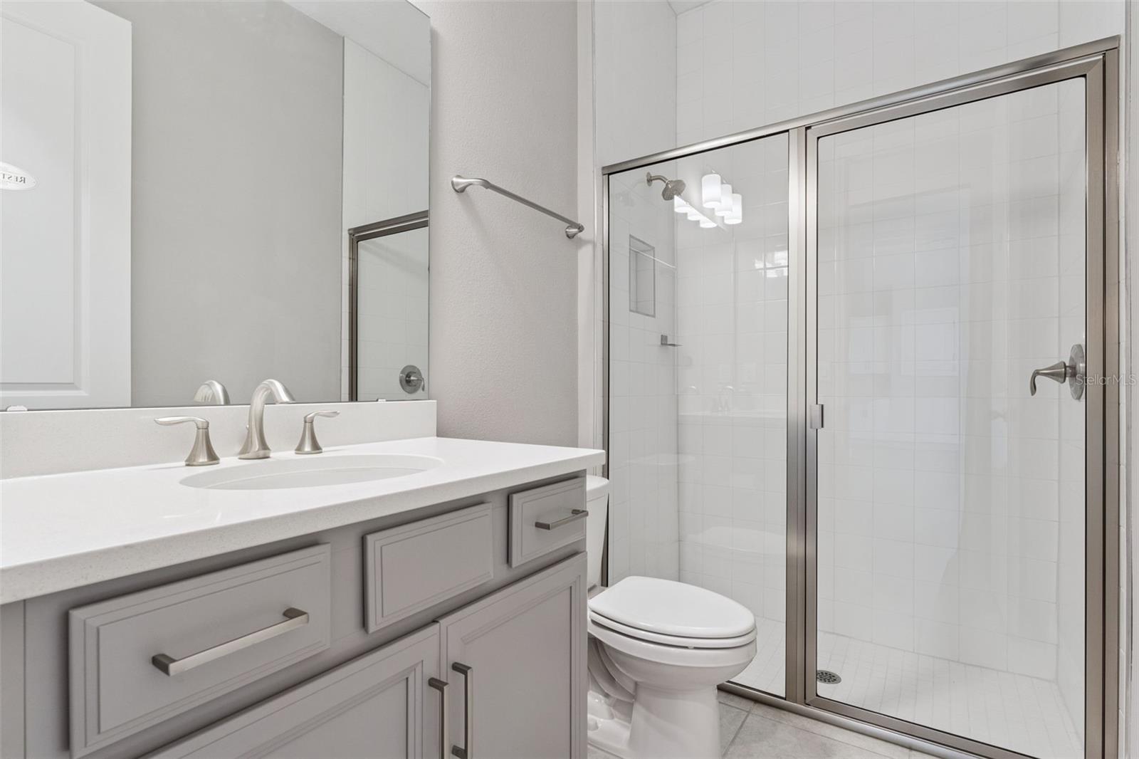 Full bathroom with modern vanity and tub/shower combination.