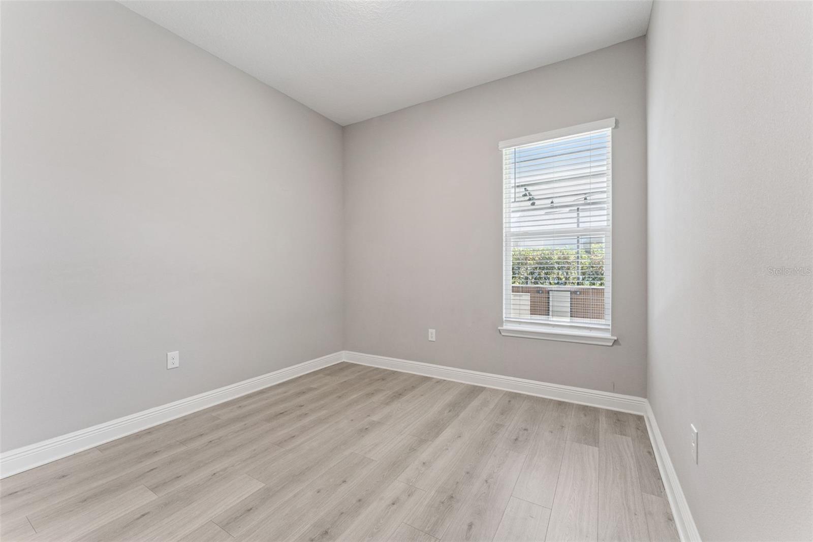 Versatile secondary bedroom with plenty of space for a home office, gym, or playroom.