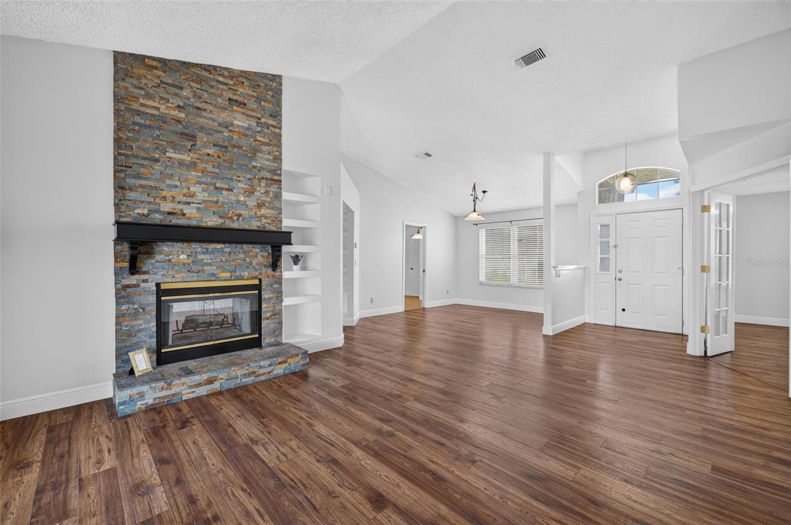 Additional design detail includes vaulted ceilings, built-in shelving, and ample natural light.