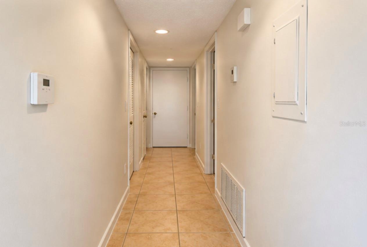 Hallway to bedrooms; laundry closet at far end right.
