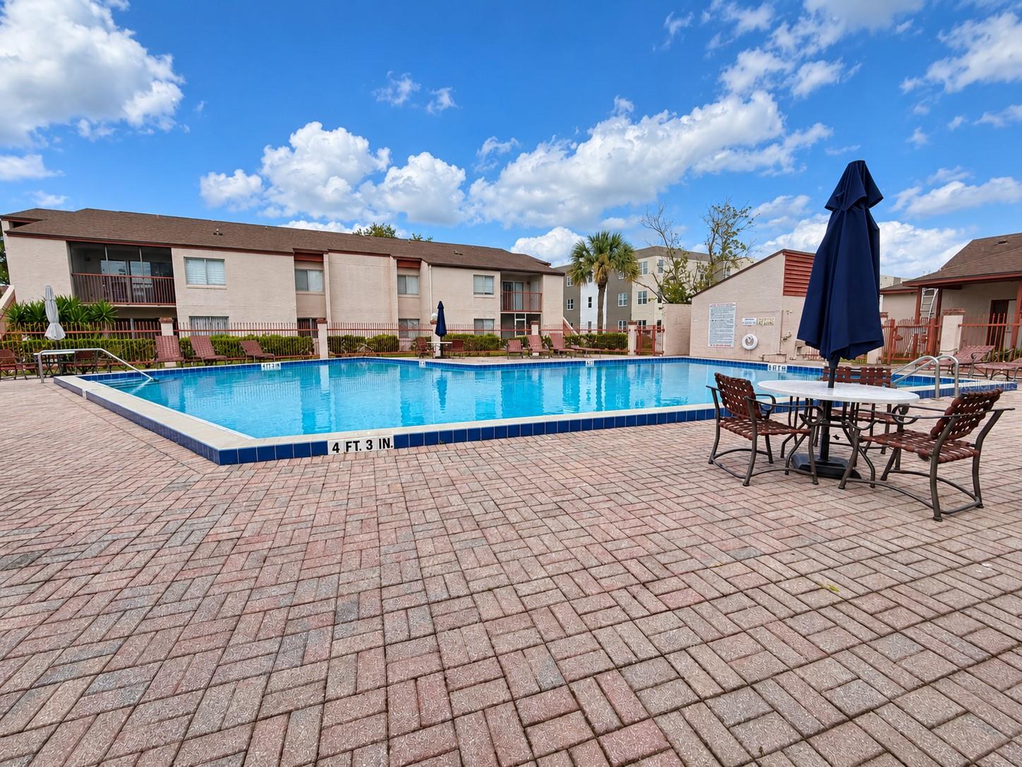 Sparkling pool and plenty of room for sunbathing on the pavered deck.