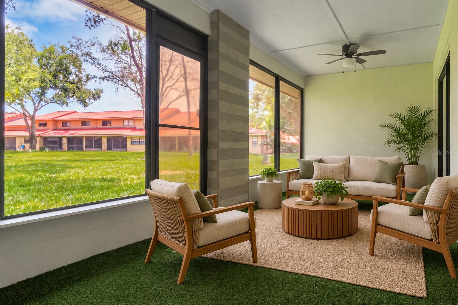 Sunroom with plenty of sunlight overlooking the green space.