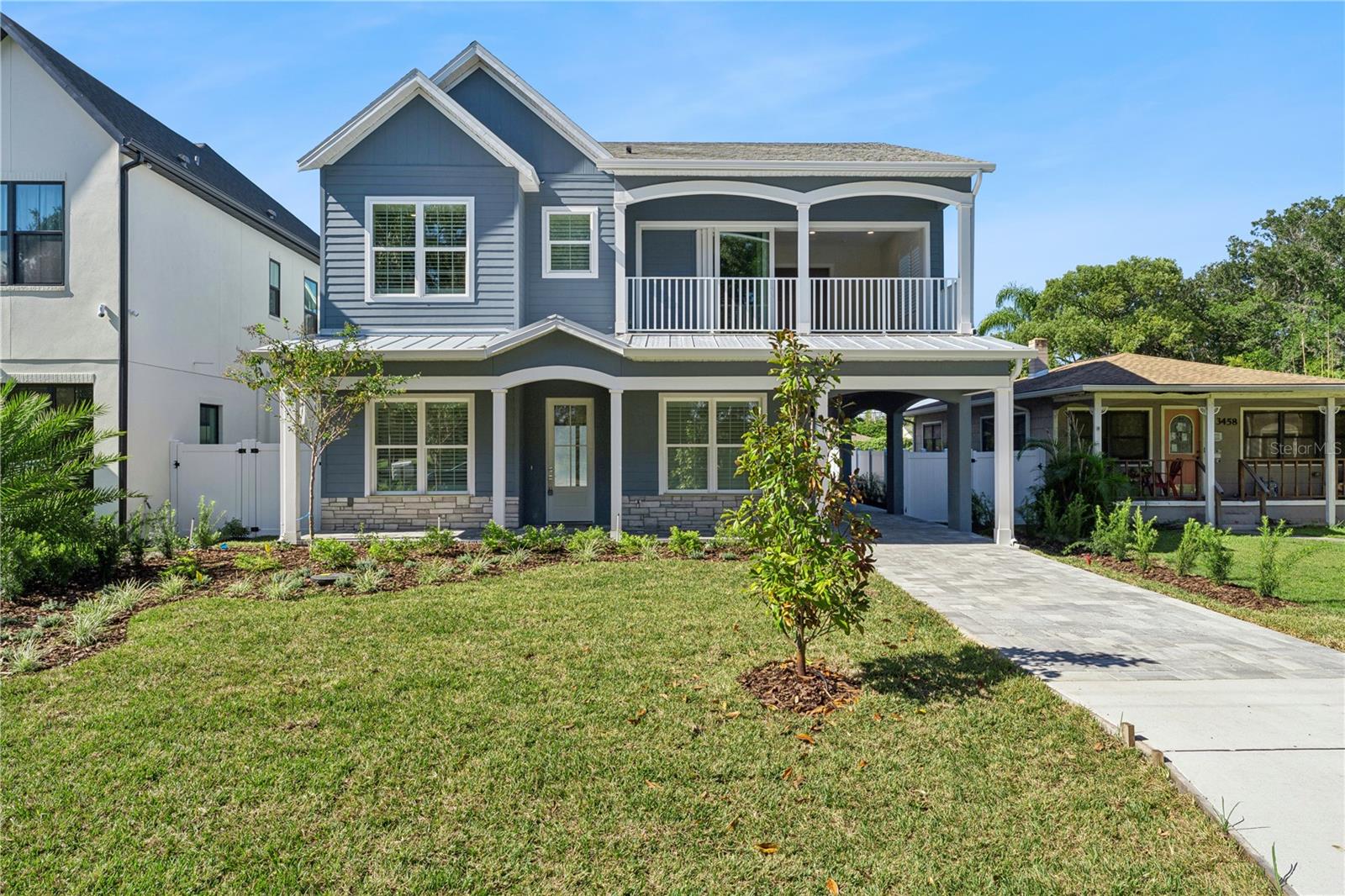 Welcoming front exterior with gabled rooflines, a covered porch, and an upper-level balcony.
