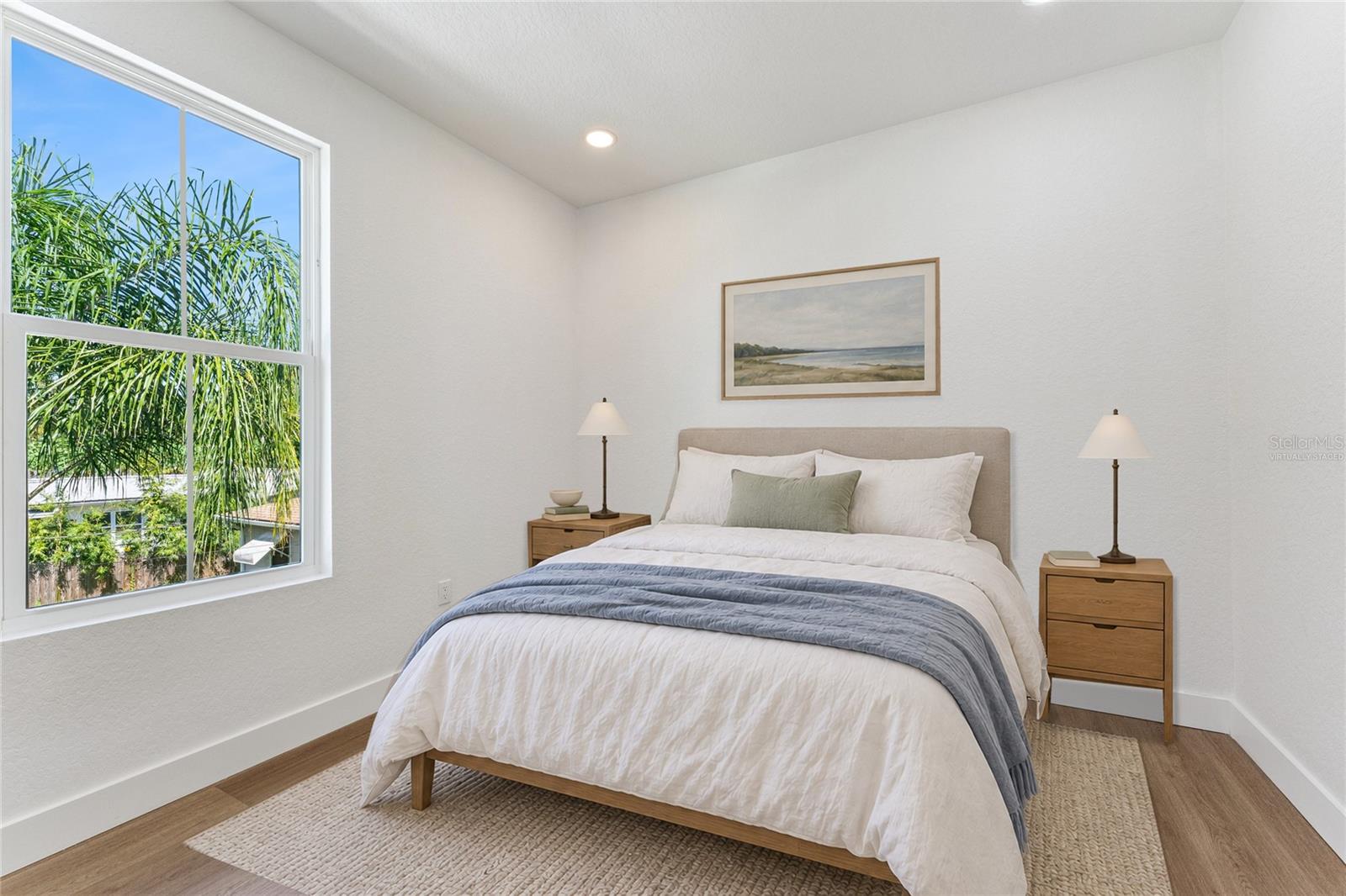 Virtually Staged - A tall window brings natural light and a leafy outlook into this room.