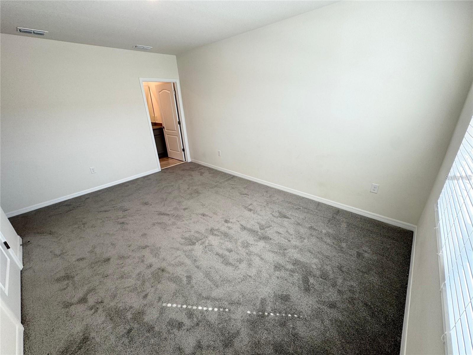 View of primary bedroom toward primary bathroom.