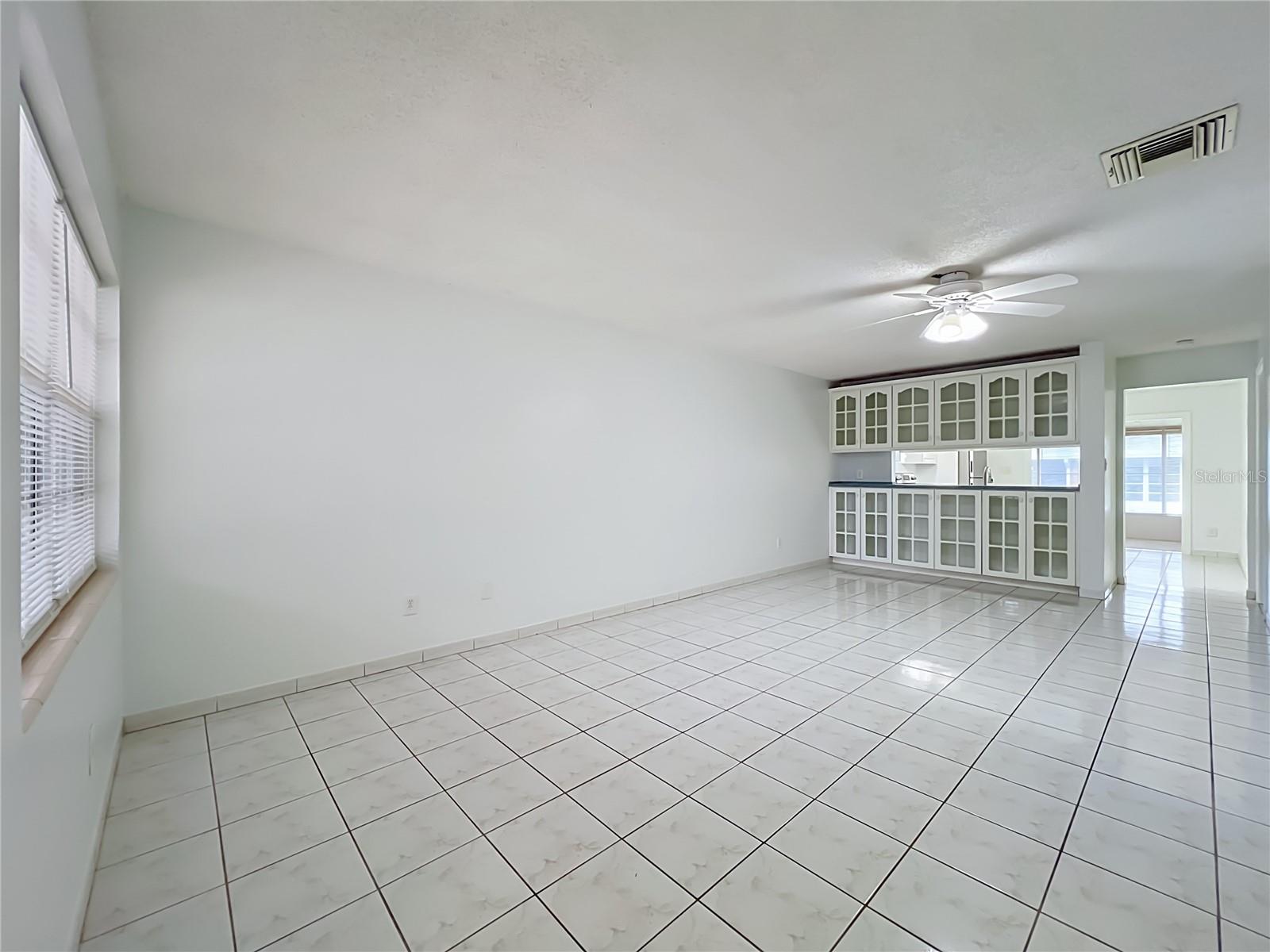 Bright and spacious living area with easy-to-maintain ceramic tile flooring.