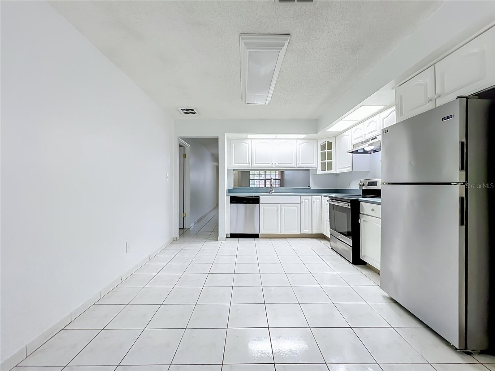 Kitchen offers additional space for a breakfast or dining area.