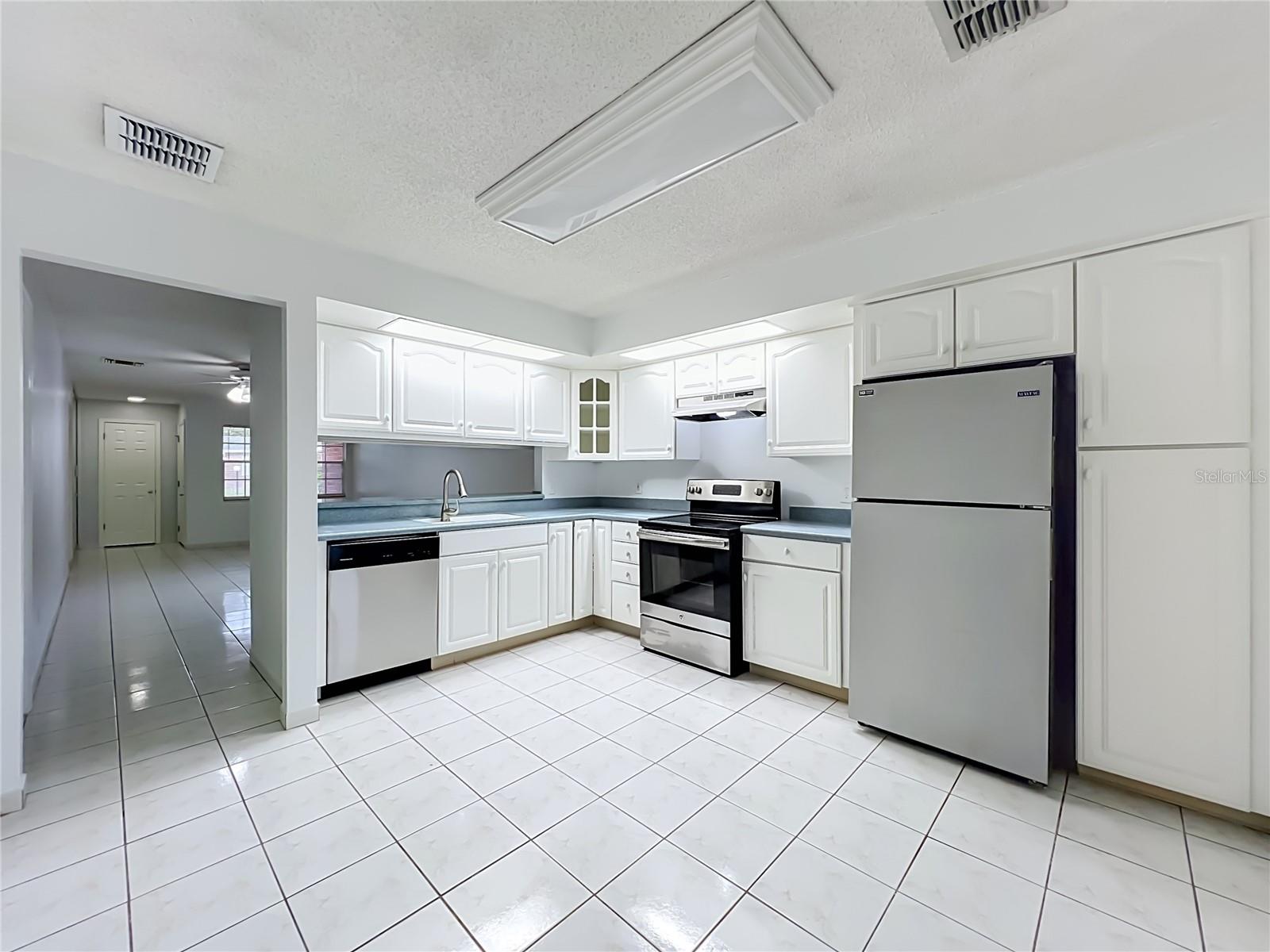 Spacious kitchen with plenty of cabinet and countertop space for everyday living.