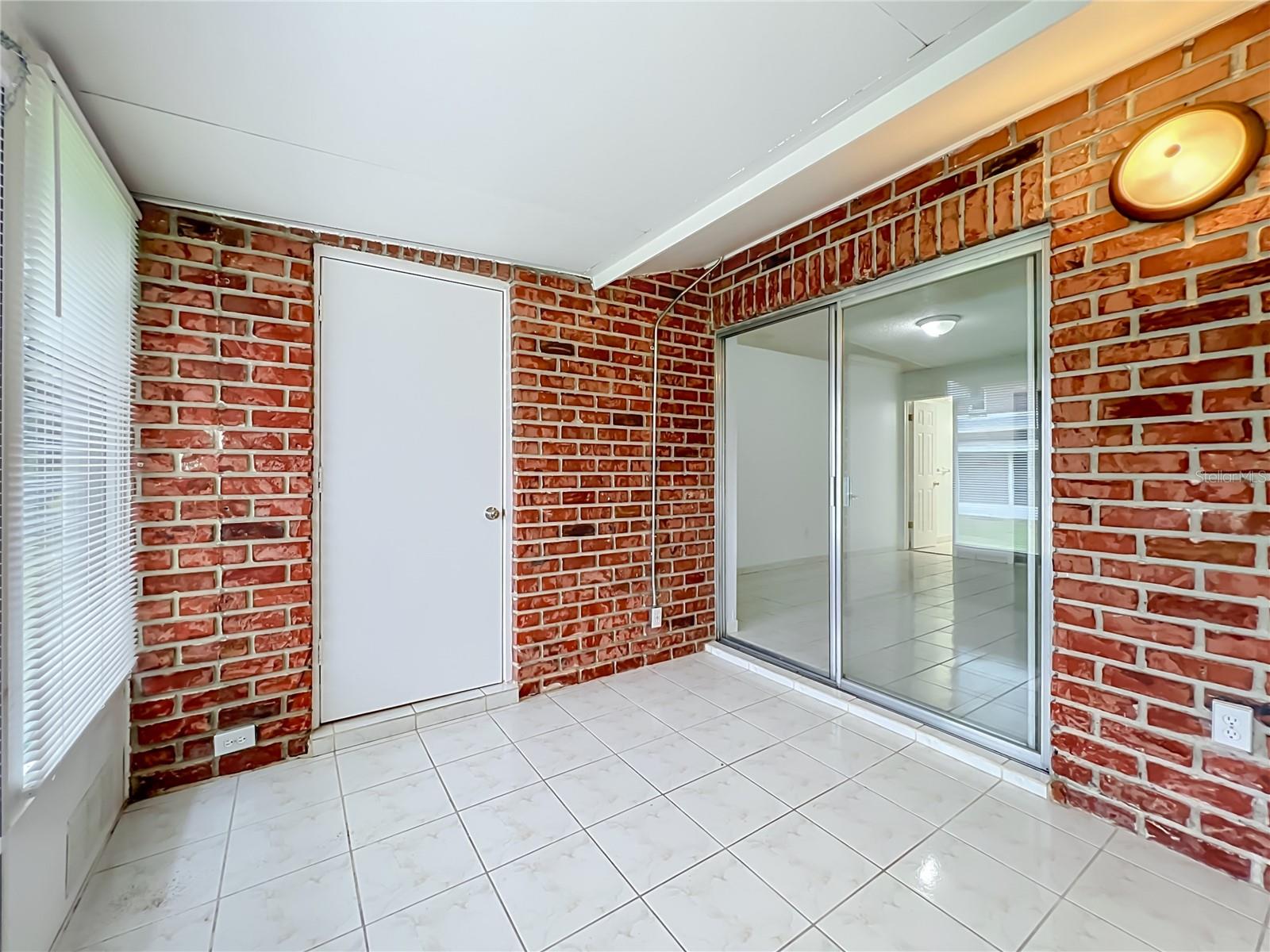 Exposed brick brings warmth and character to the spacious Florida room.