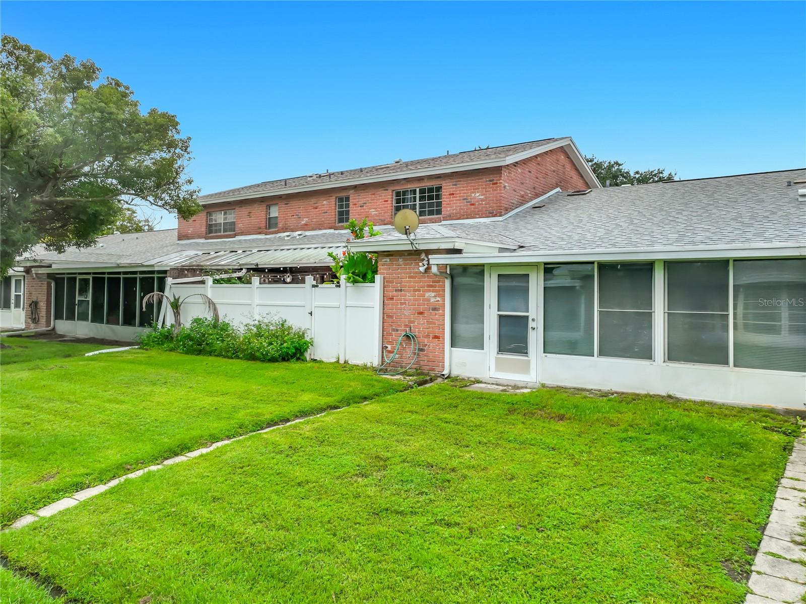 Another look at the home's exterior and surrounding green space.
