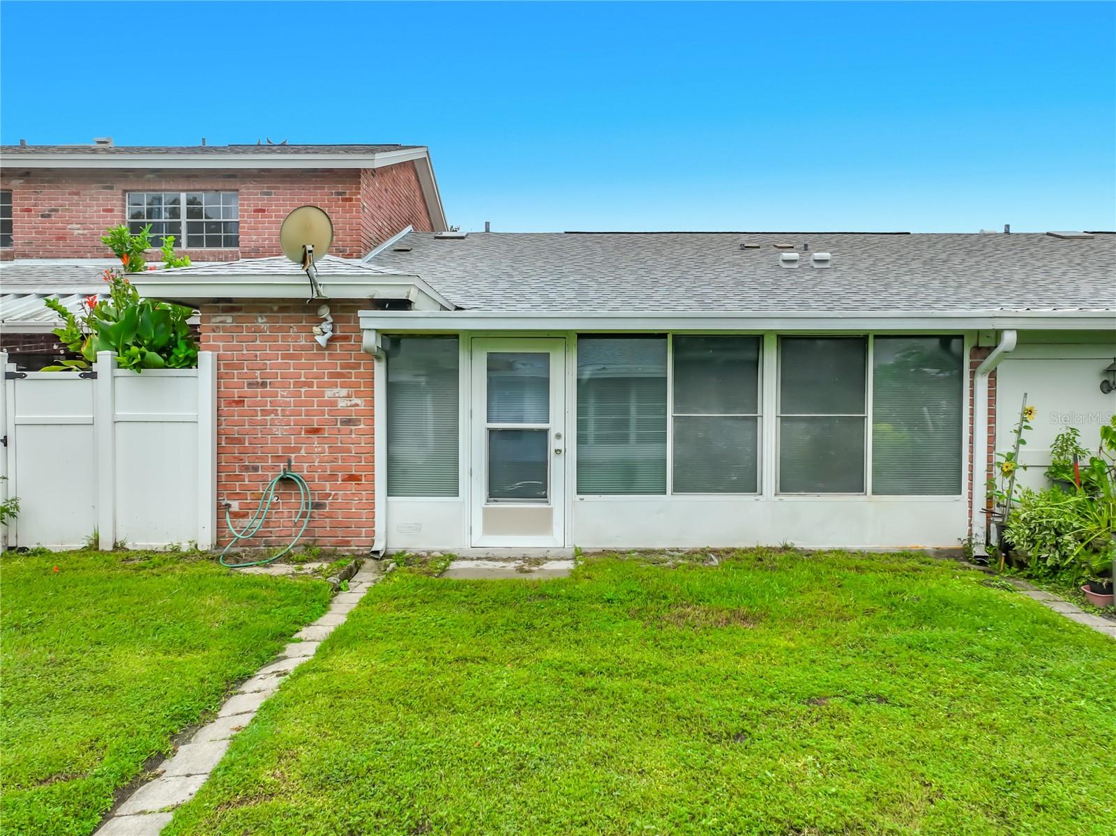 Rear exterior view of this charming one-story home.