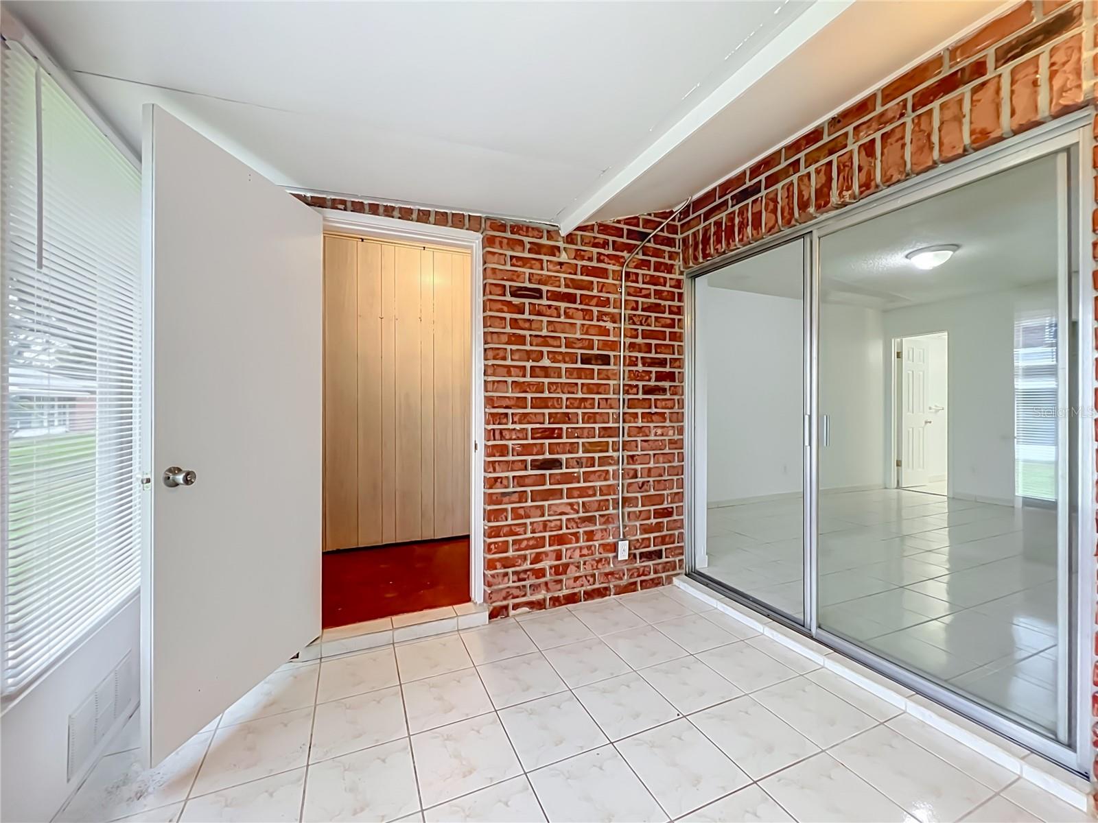 Enclosed Florida room adds valuable flexible space to enjoy year-round.
