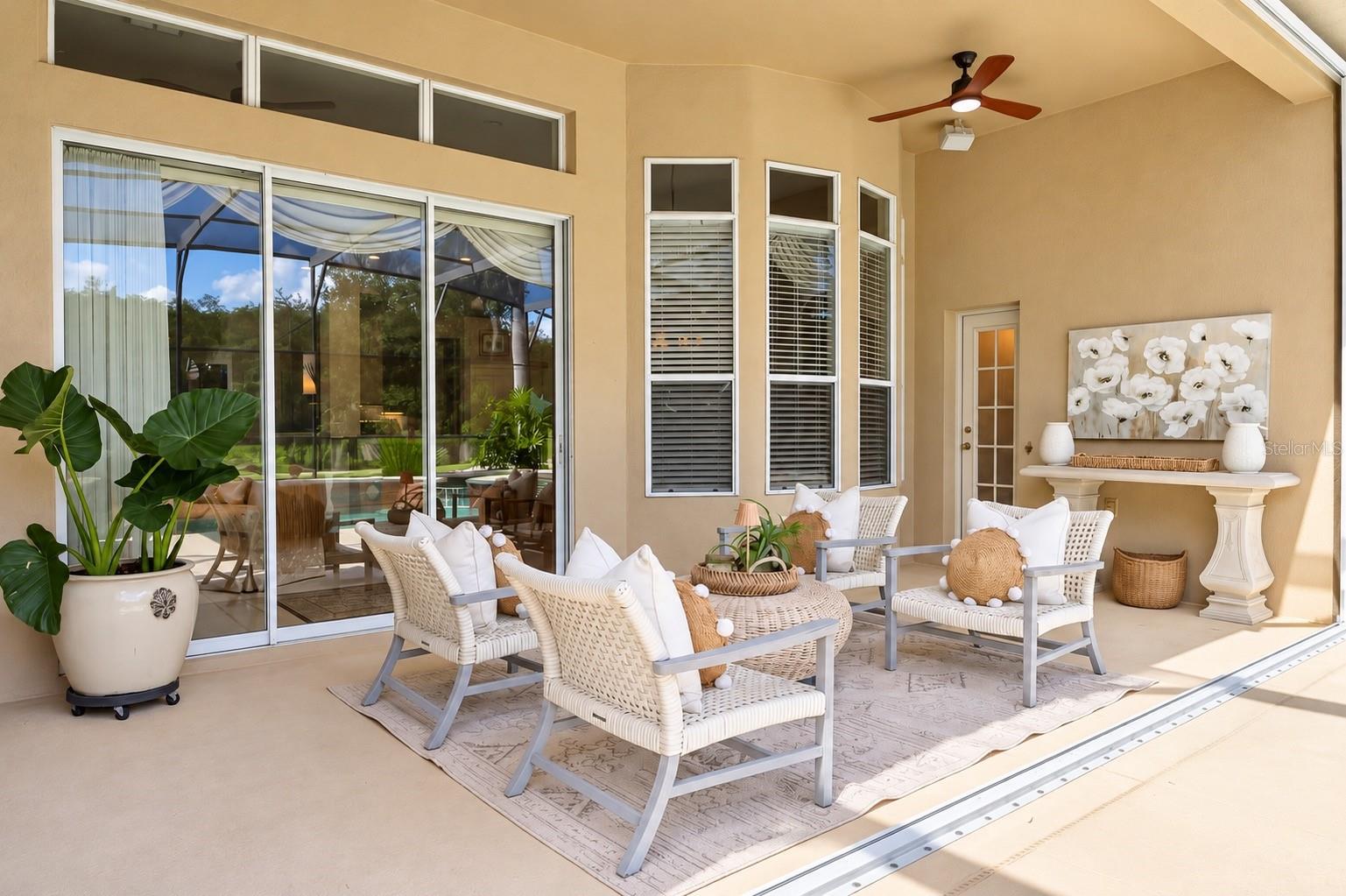 STUNNING, SPACIOUS COVERED LANAI FEATURING SOARING CEILINGS, BEAUTIFUL ARCHITECTURAL DETAILS, AND A CEILING FAN, CREATING THE PERFECT SPACE FOR RELAXING, ENTERTAINING, AND ENJOYING FLORIDA'S INDOOR-OUTDOOR LIFESTYLE!