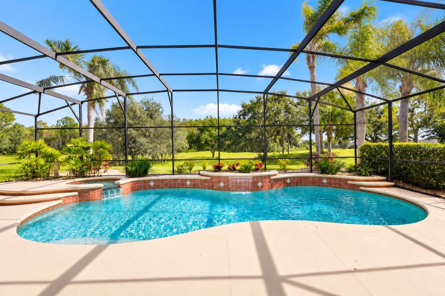 YOUR OWN PRIVATE TROPICAL PARADISE! STUNNING SCREEN-ENCLOSED, CUSTOM-DESIGNED POOL WITH BEAUTIFUL WATERFALL FEATURES, RAISED SPA, AND LUSH TROPICAL LANDSCAPING! Enjoy breathtaking views of the expansive green space with NO REAR NEIGHBORS, offering a peaceful and picturesque setting perfect for relaxing, entertaining, and enjoying the Florida lifestyle year-round!