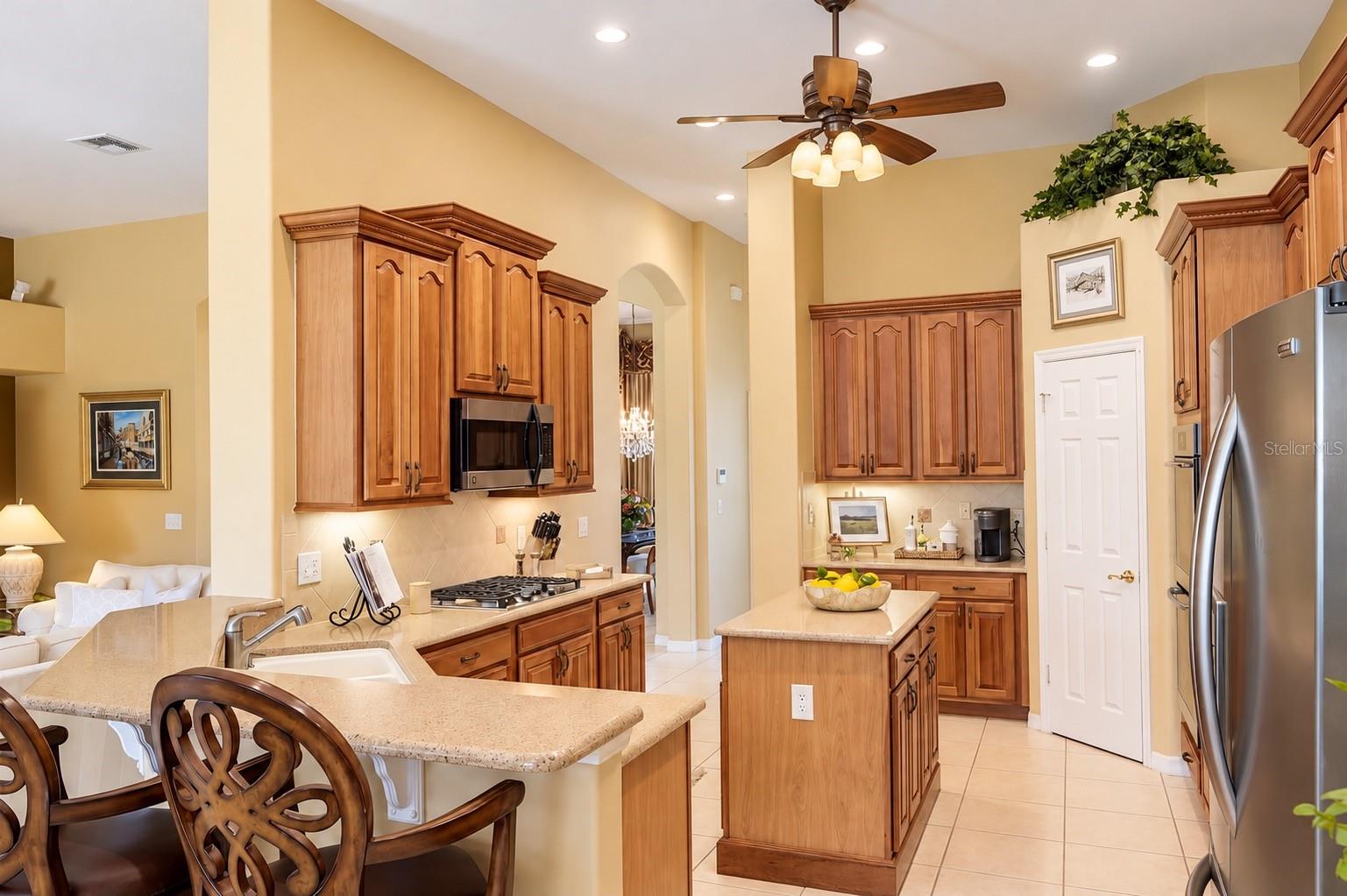 BEAUTIFULLY DESIGNED, SPACIOUS KITCHEN FEATURING SOARING CEILINGS, GORGEOUS WOOD CABINETRY, ABUNDANT COUNTER SPACE, AND STAINLESS STEEL APPLIANCES! Enjoy a CENTER ISLAND, BREAKFAST BAR WITH ADDITIONAL SEATING, GAS COOKTOP, UNDER-CABINET LIGHTING, AND RECESSED LIGHTING! BEAUTIFULLY DESIGNED, SPACIOUS KITCHEN FEATURING SOARING CEILINGS, GORGEOUS WOOD CABINETRY, ABUNDANT COUNTER SPACE, AND STAINLESS STEEL APPLIANCES! Enjoy a CENTER ISLAND, BREAKFAST BAR WITH ADDITIONAL SEATING, GAS COOKTOP, UNDER-CABINET LIGHTING, AND RECESSED LIGHTING!