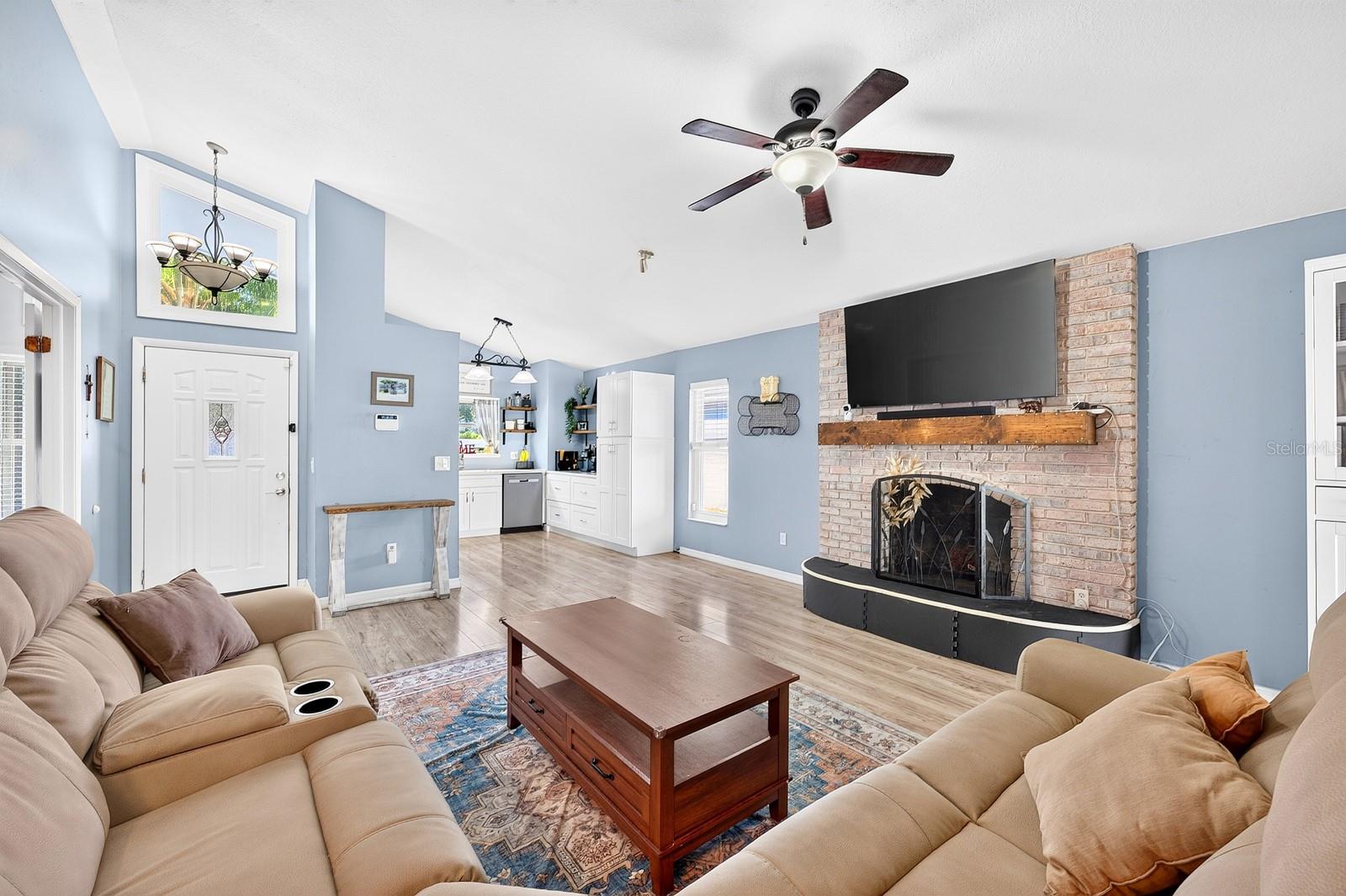 Light, bright open concept living under vaulted ceilings.
