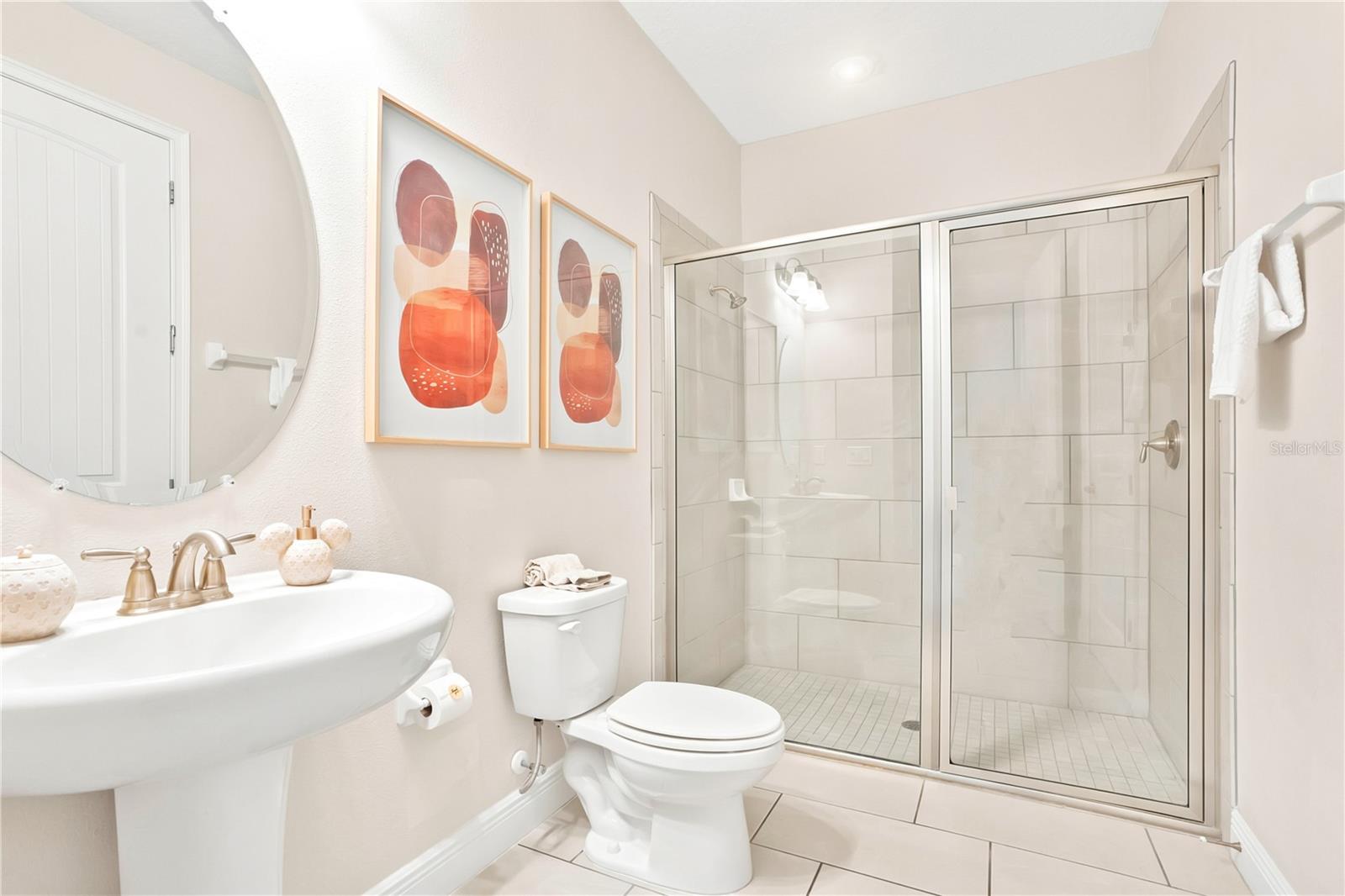 Bright, beautifully finished en-suite bath with a glass-enclosed shower