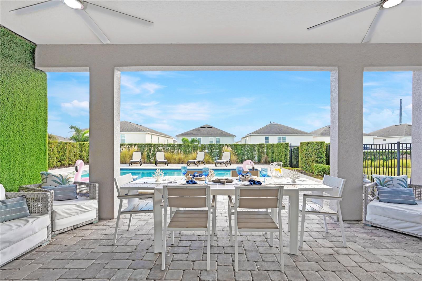 Covered outdoor dining overlooking the private pool and tropical landscaping