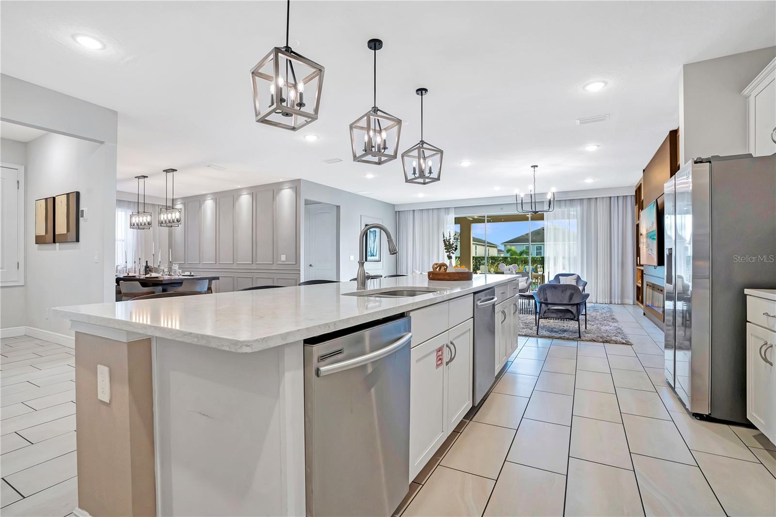 An expansive kitchen with oversized island opens directly to the main gathering spaces, creating a seamless environment for entertaining large groups