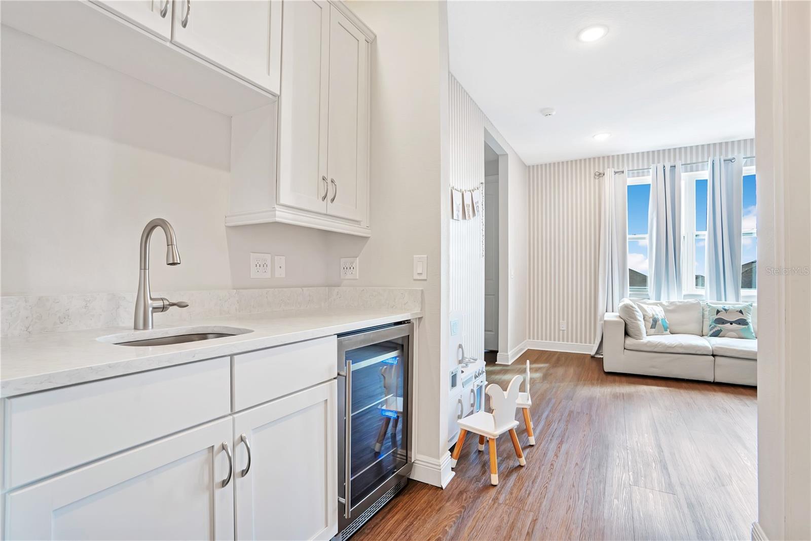 The Jungle Book Lounge features a wet bar with granite countertops and a wine refrigerator.