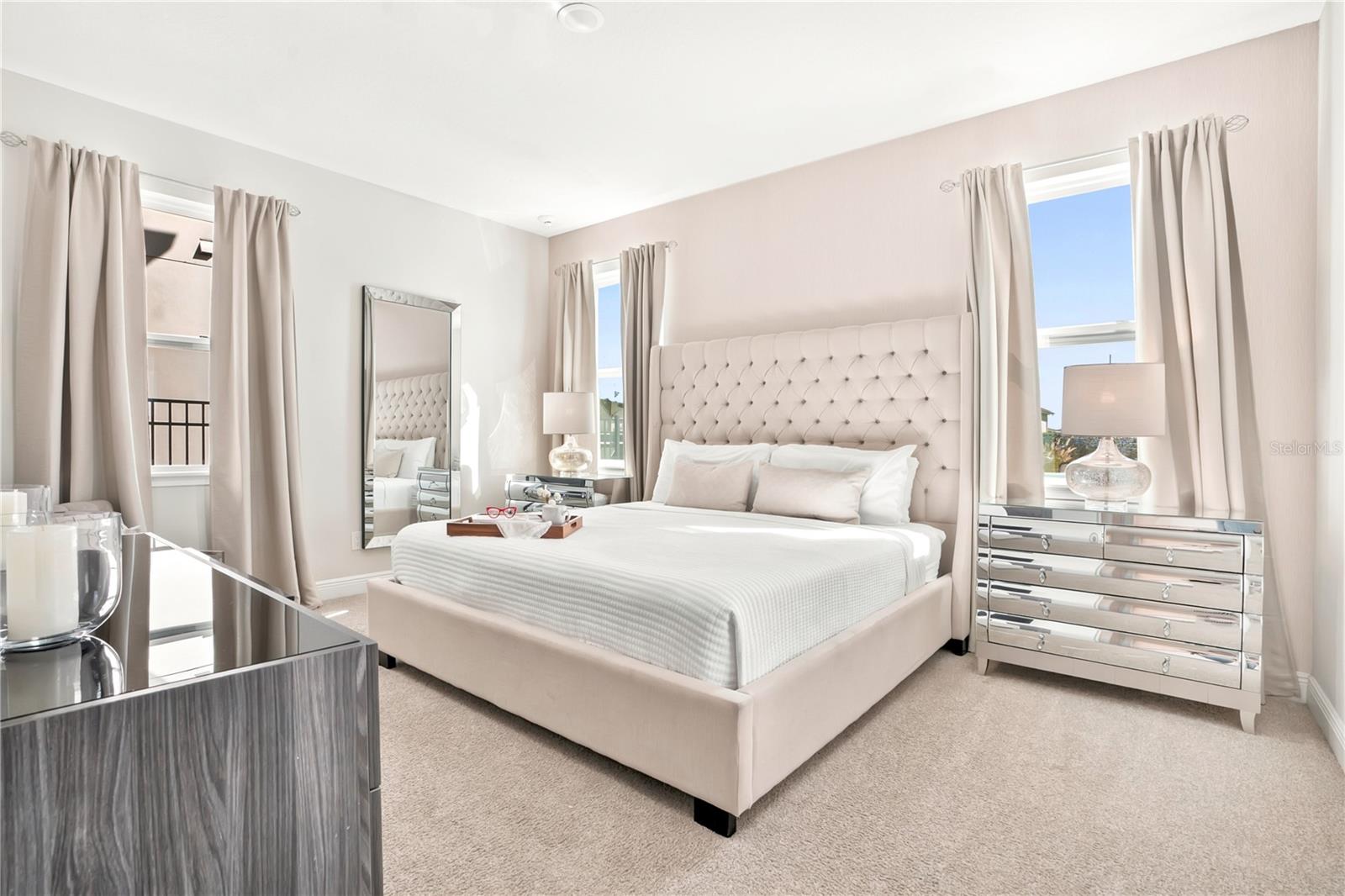 The first floor elegant primary suite with soft neutrals and timeless designer furnishings