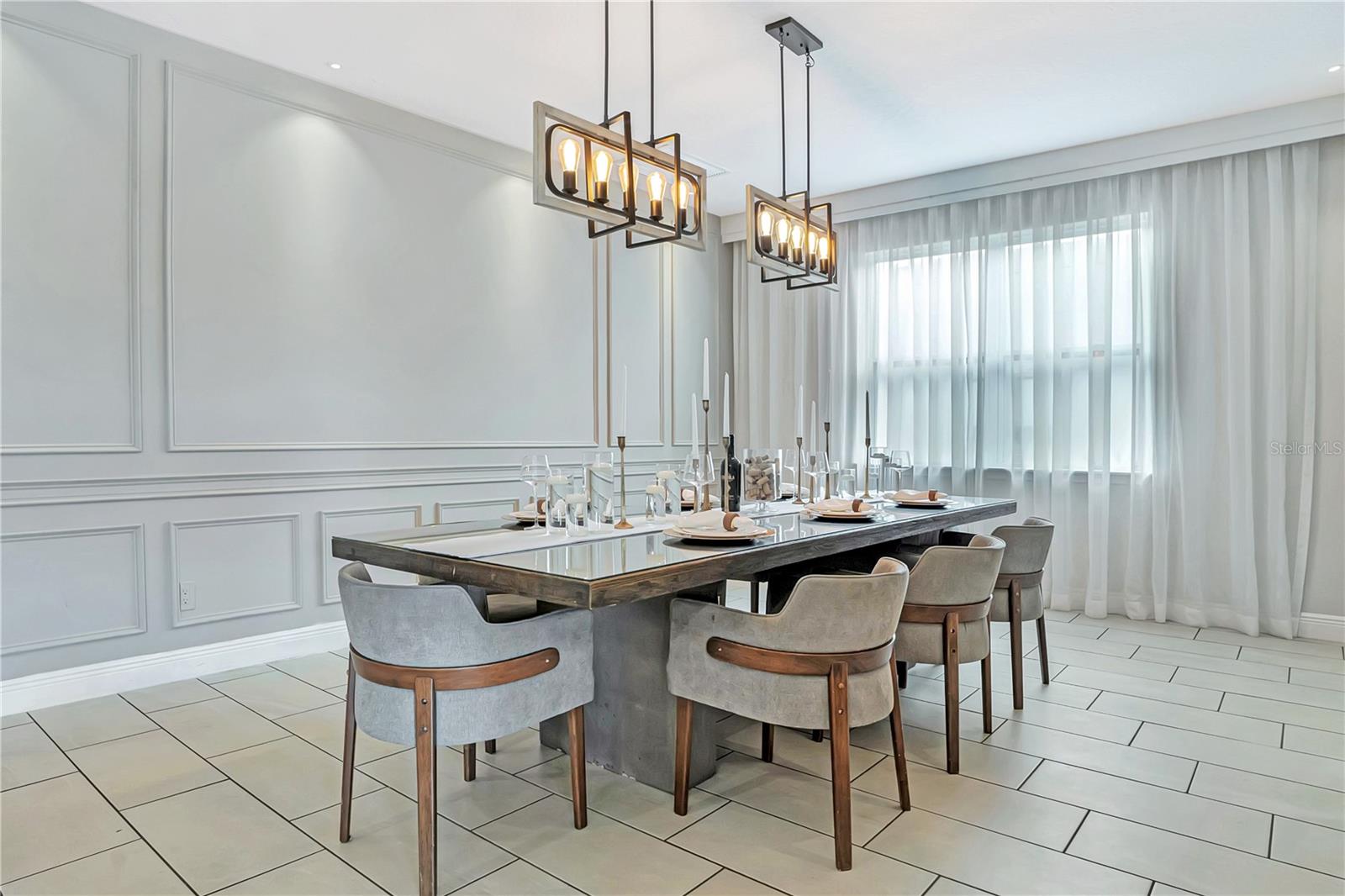 An elegant dining experience with sophisticated architectural detailing, statement lighting, and generous space for memorable meals together