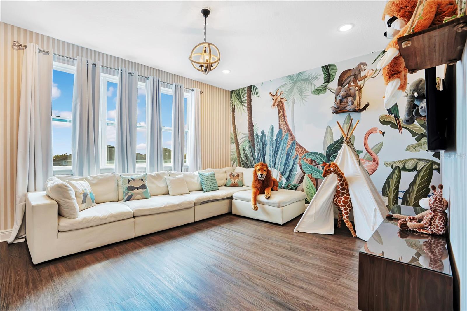 An enchanting Jungle Book-inspired loft brings the magic of the jungle to life with vibrant custom murals, whimsical details, and a welcoming space for guests of all ages to gather and unwind