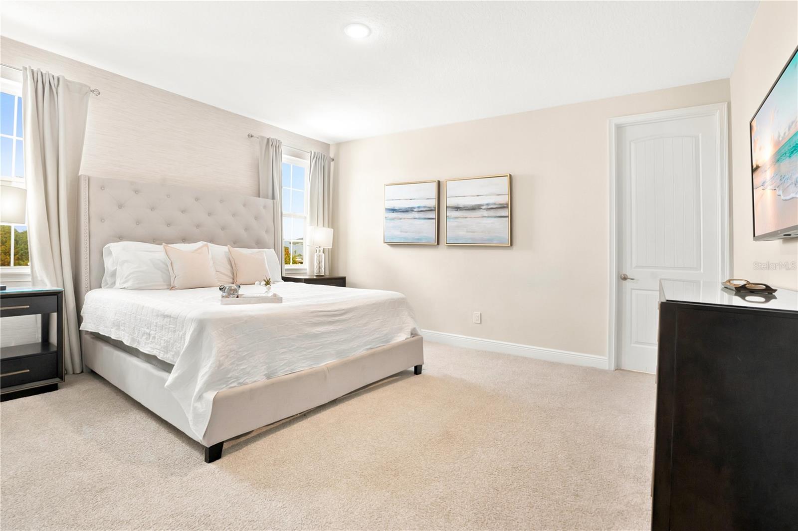 A peaceful second upstairs suite with elegant furnishings and a soft, neutral palette