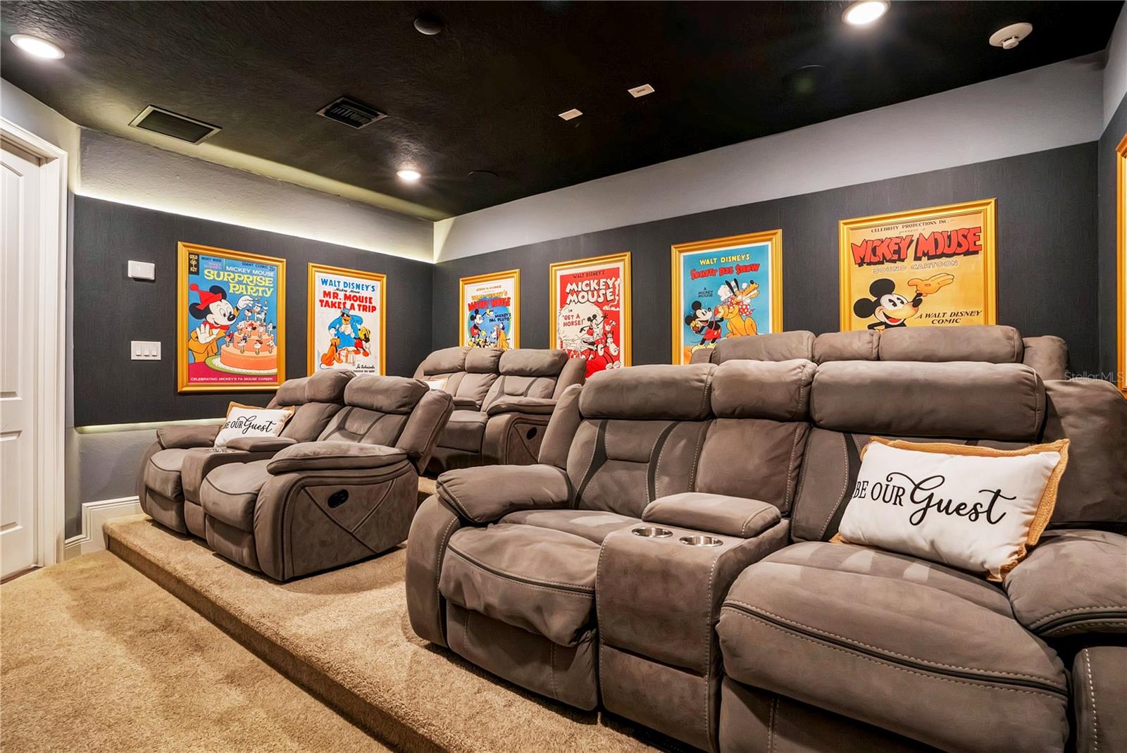 The Wonderful World of Disney Theater delivers a cinematic experience with plush reclining seating, dramatic lighting, and vibrant Disney-inspired artwork