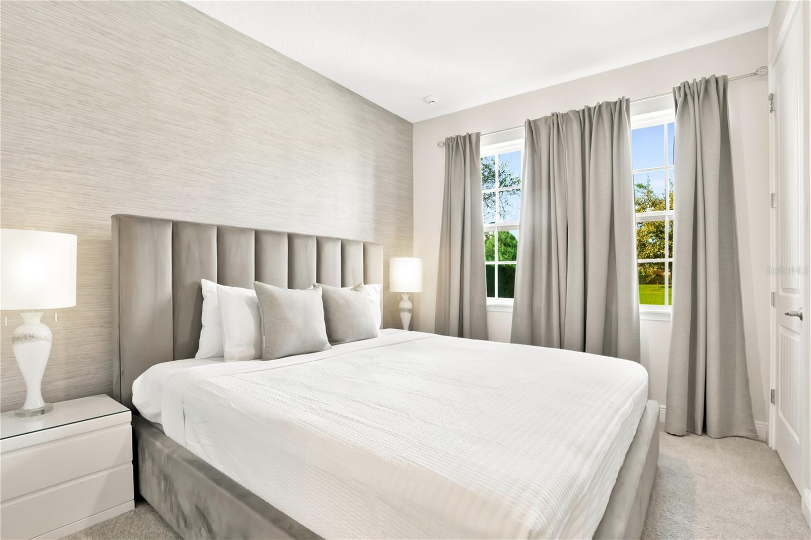 A serene guest suite with elegant furnishings, soft neutral tones, and beautiful natural light