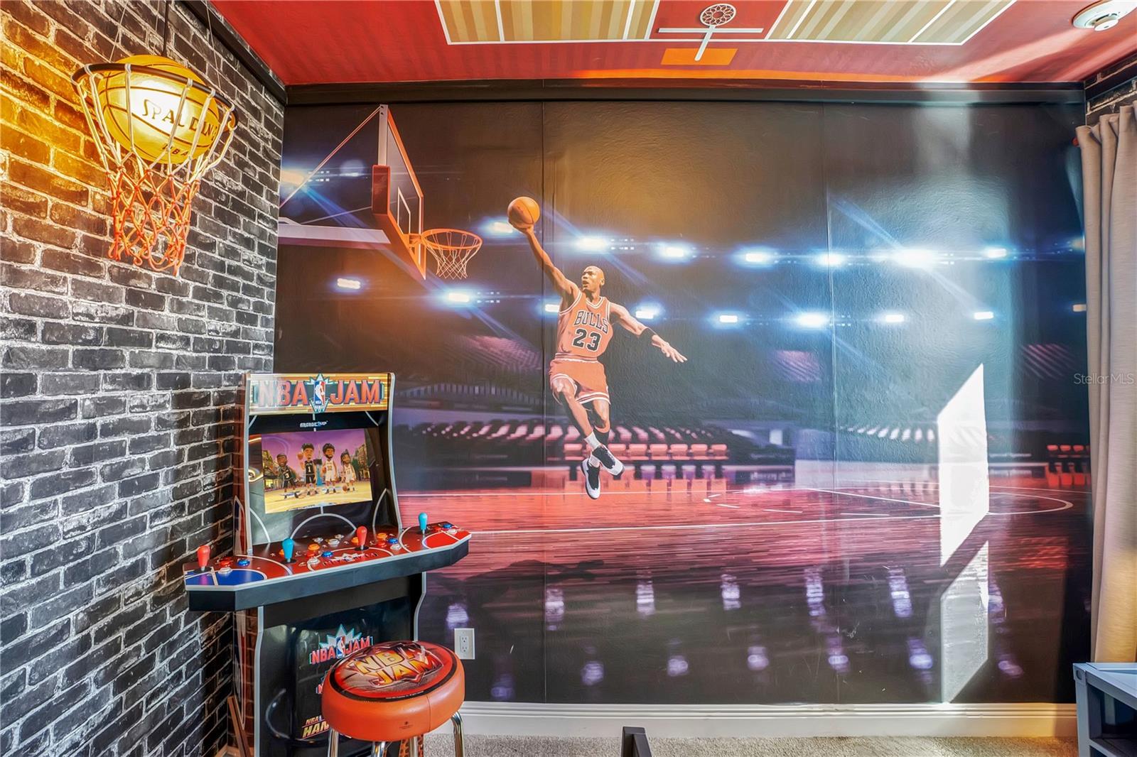Courtside inspiration! Custom basketball murals bring the energy of the game into this themed retreat