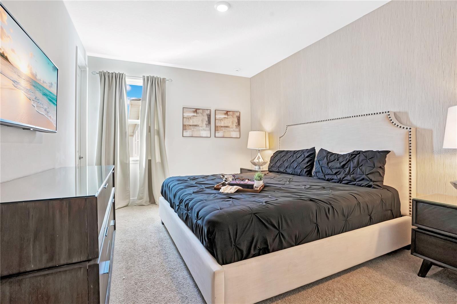 Another primary suite featuring sophisticated styling and beautifully coordinated furnishings