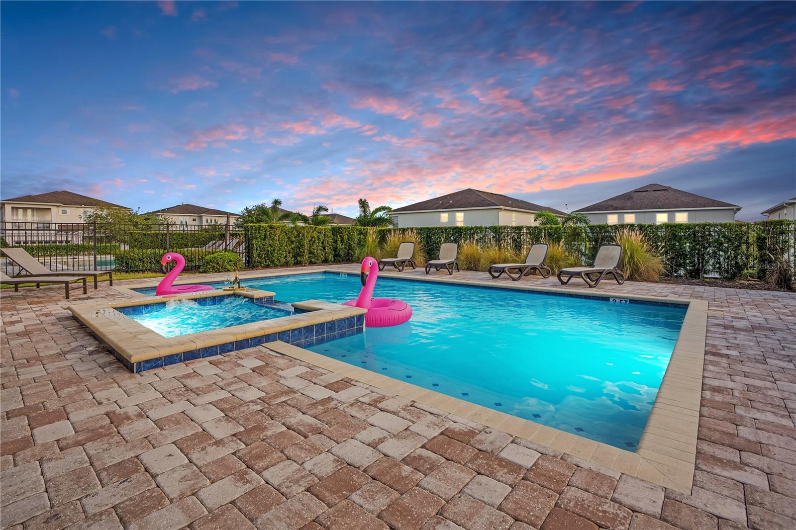 Your private resort experience awaits, featuring a spectacular pool, expansive paver deck, and inviting outdoor spaces for relaxation and entertainment