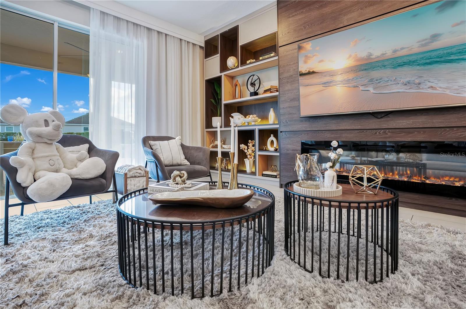 Custom built-ins, integrated lighting, and a striking fireplace feature