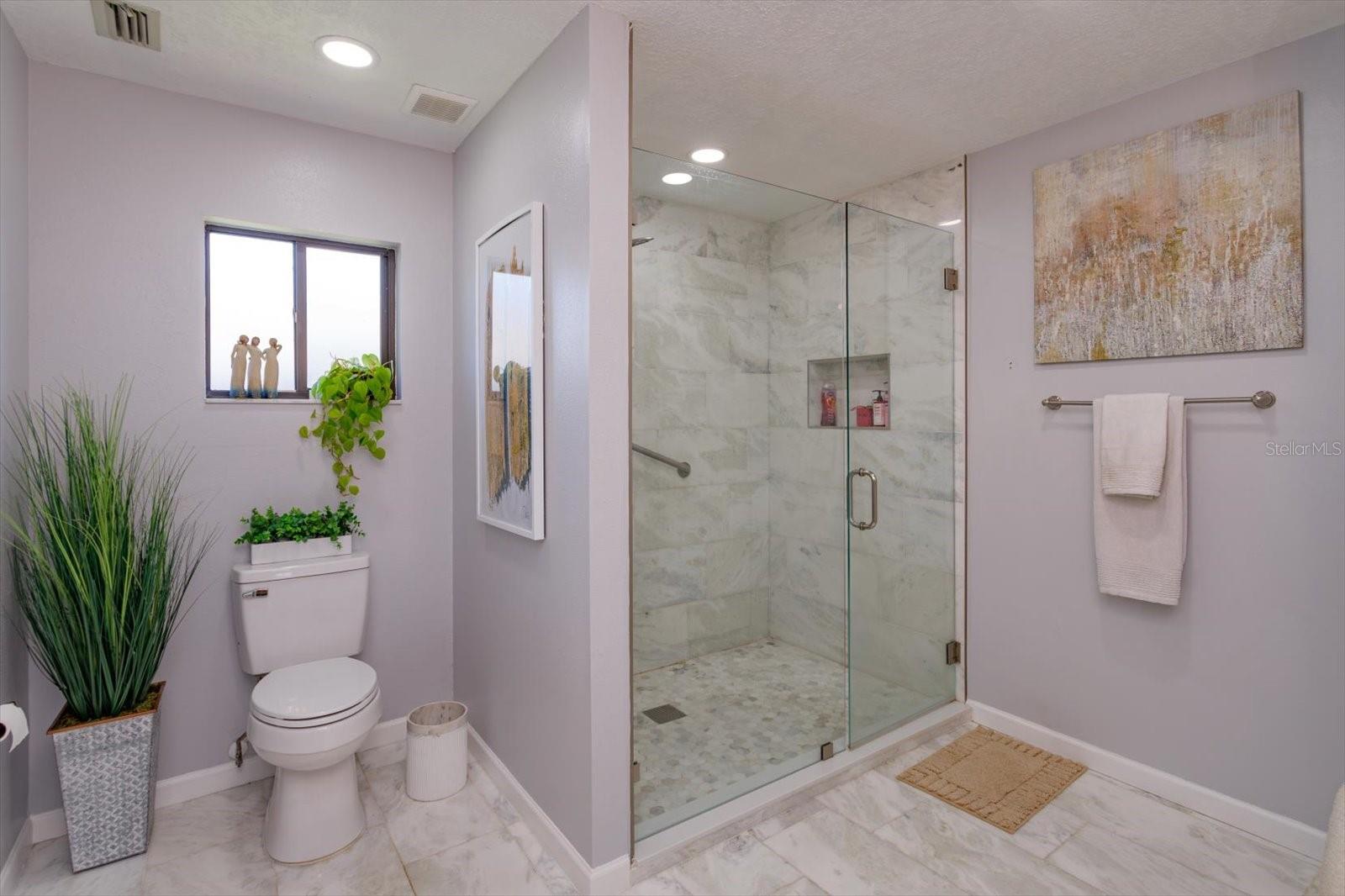 Seamless glass shower enclosure