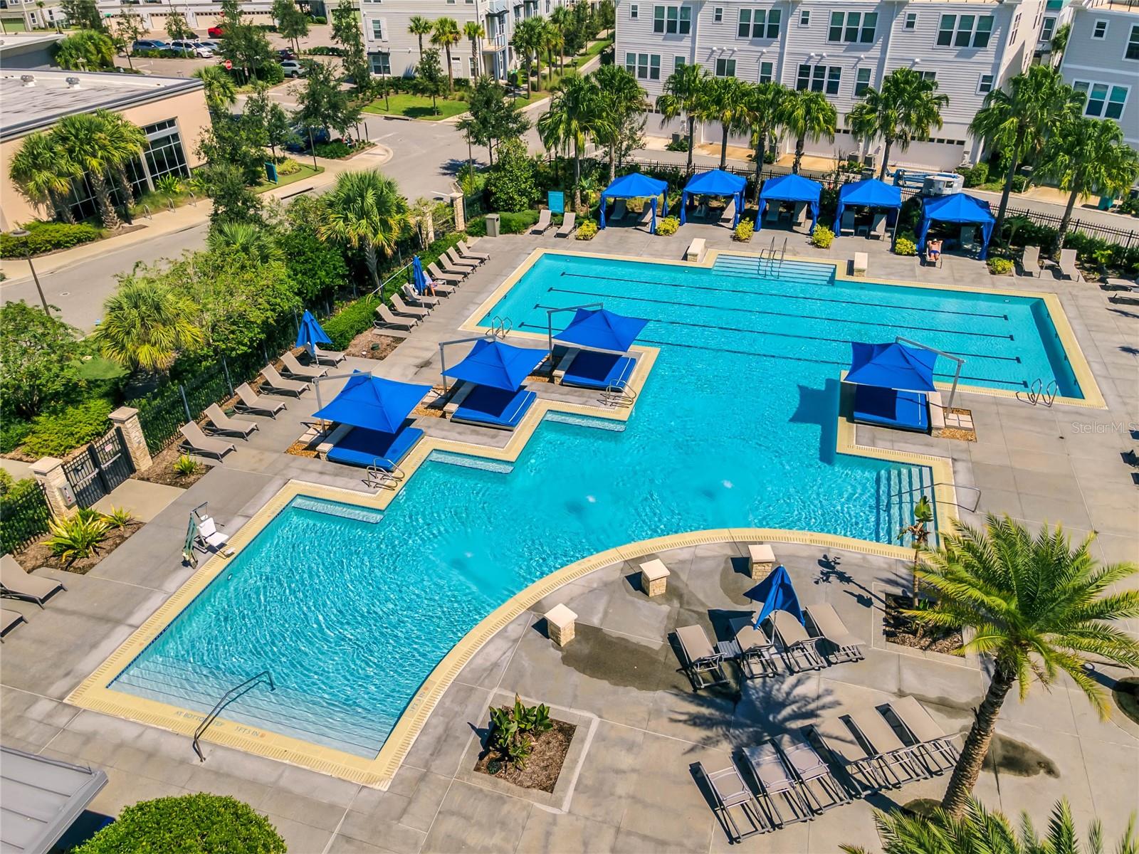 Community pool with shaded cabanas and sun deck in Laureate Park, Orlando FL 32827.