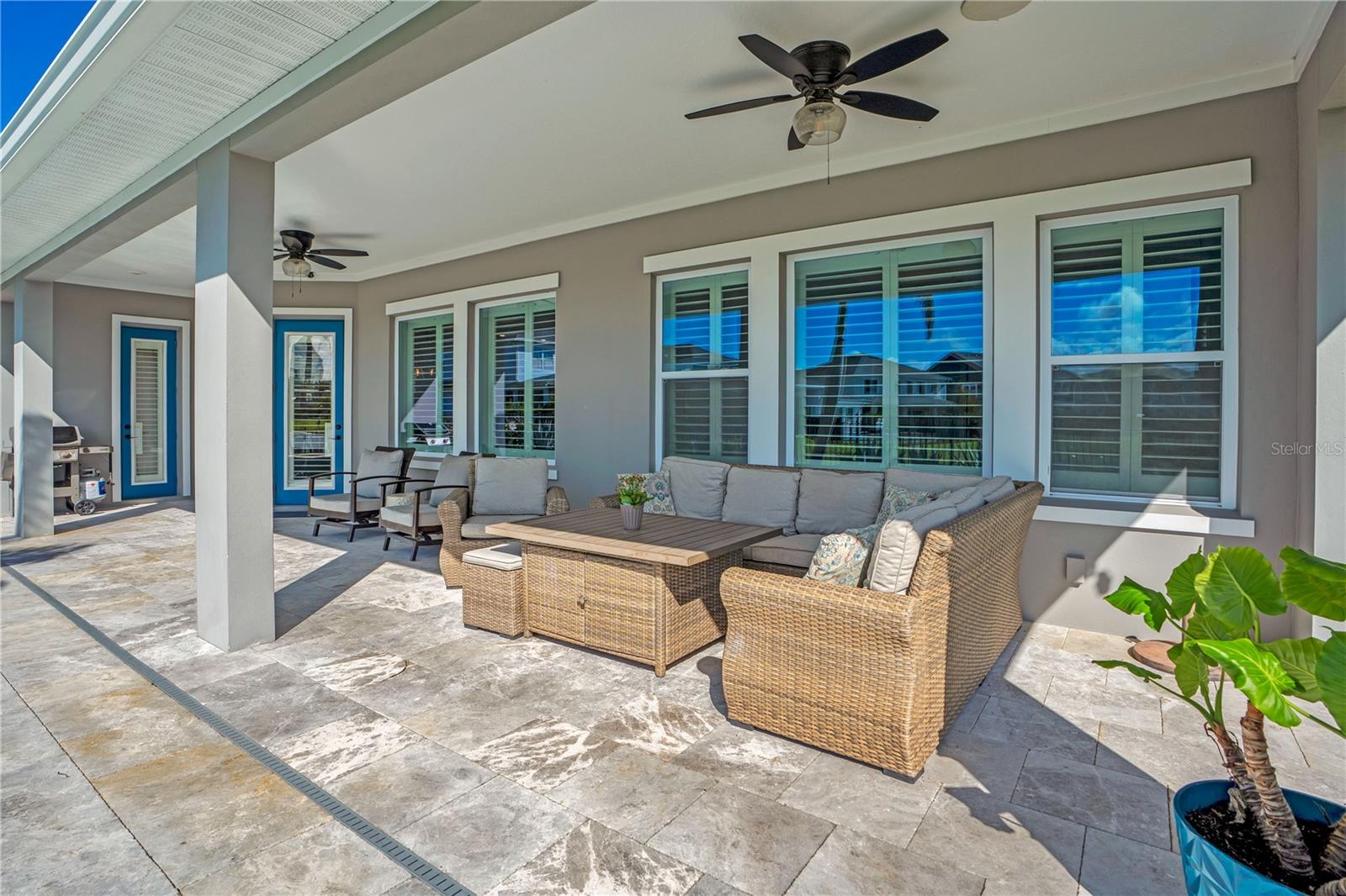 Covered lanai lounge with ceiling fan, perfect for relaxing year round in Central Florida.