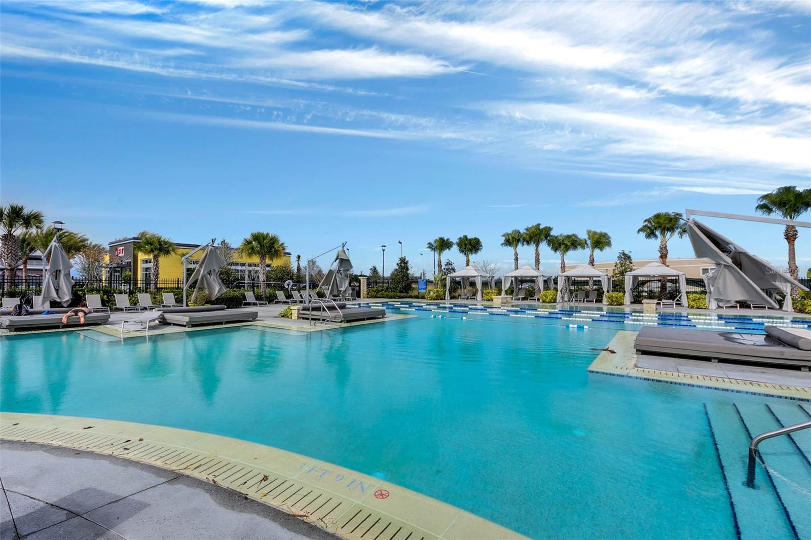 Sparkling community pool with water slide and sun deck, an everyday resort experience in Lake Nona.