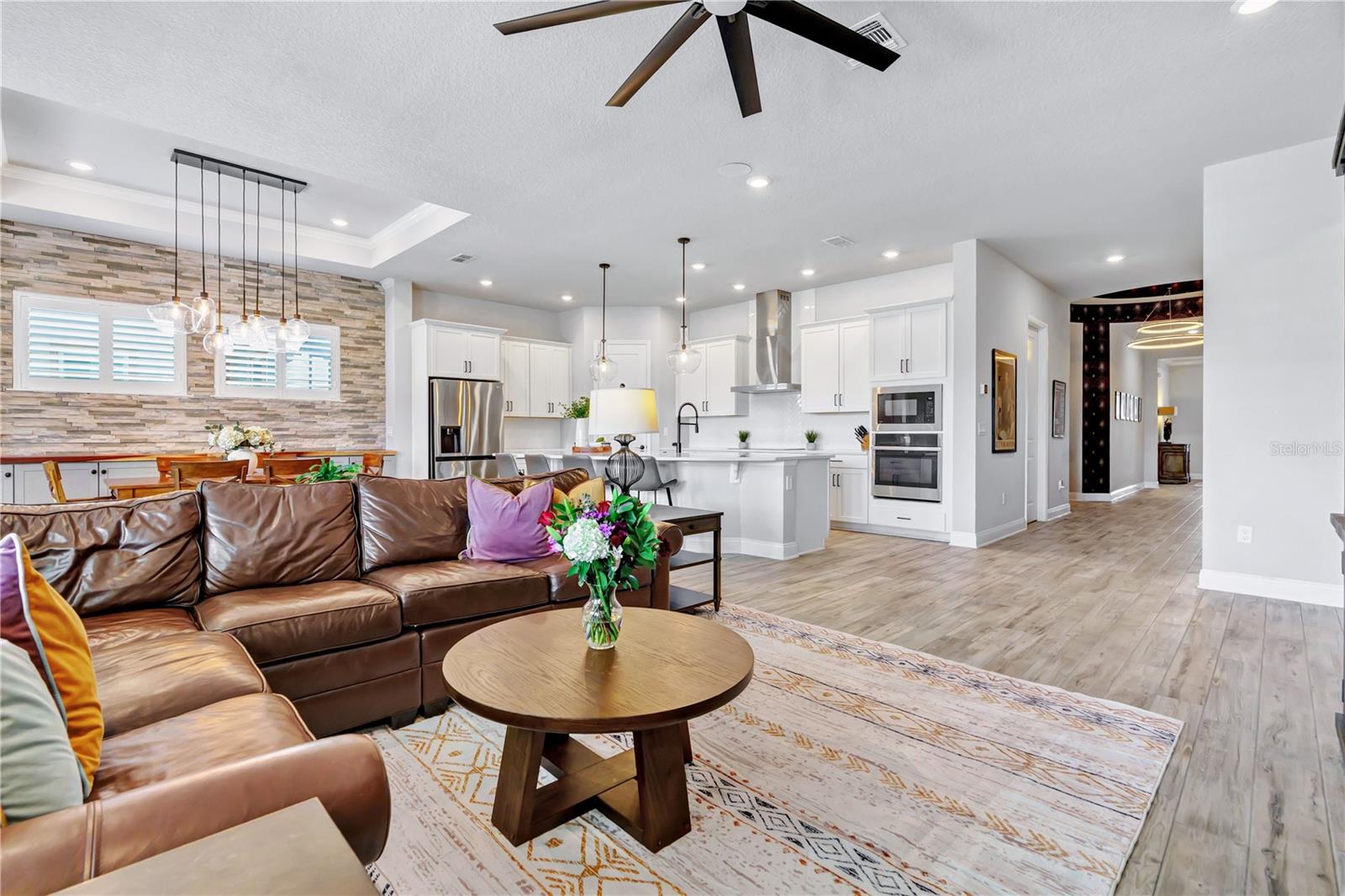 Living area designed for gathering, open to the kitchen and dining space. A natural flow for entertaining in this Orlando 32827 home.