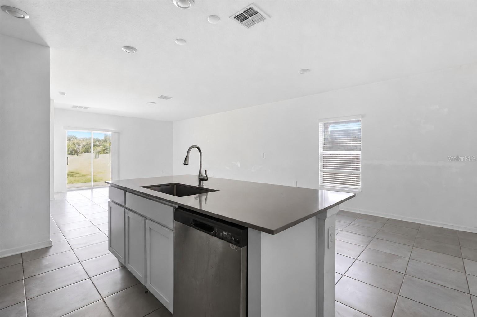 Kitchen comes with an island with stone counters