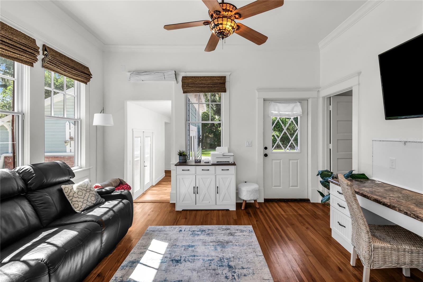 Home Office with custom built in desk and access to laundry room.