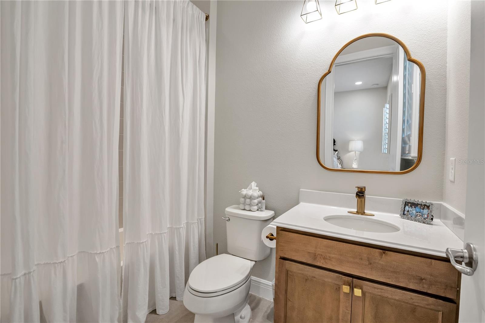 Bright bathroom featuring a contemporary vanity and stylish fixtures.