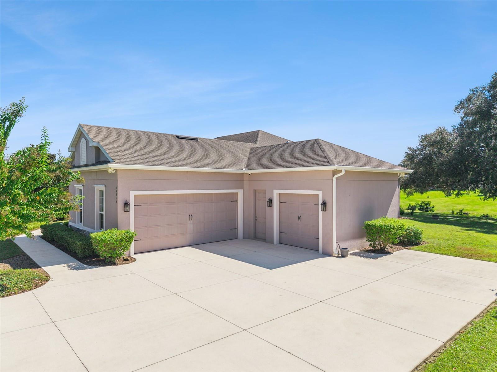 Spacious 3 car garage with storage racks and room for all your vehicles
