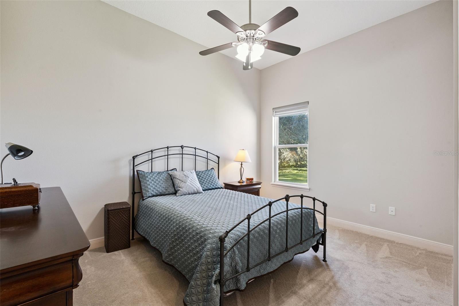 Bedroom 3 features a spacious walk-in closet, a ceiling fan for climate control, and a neutral paint palette that serves as a perfect blank canvas for any dcor style.