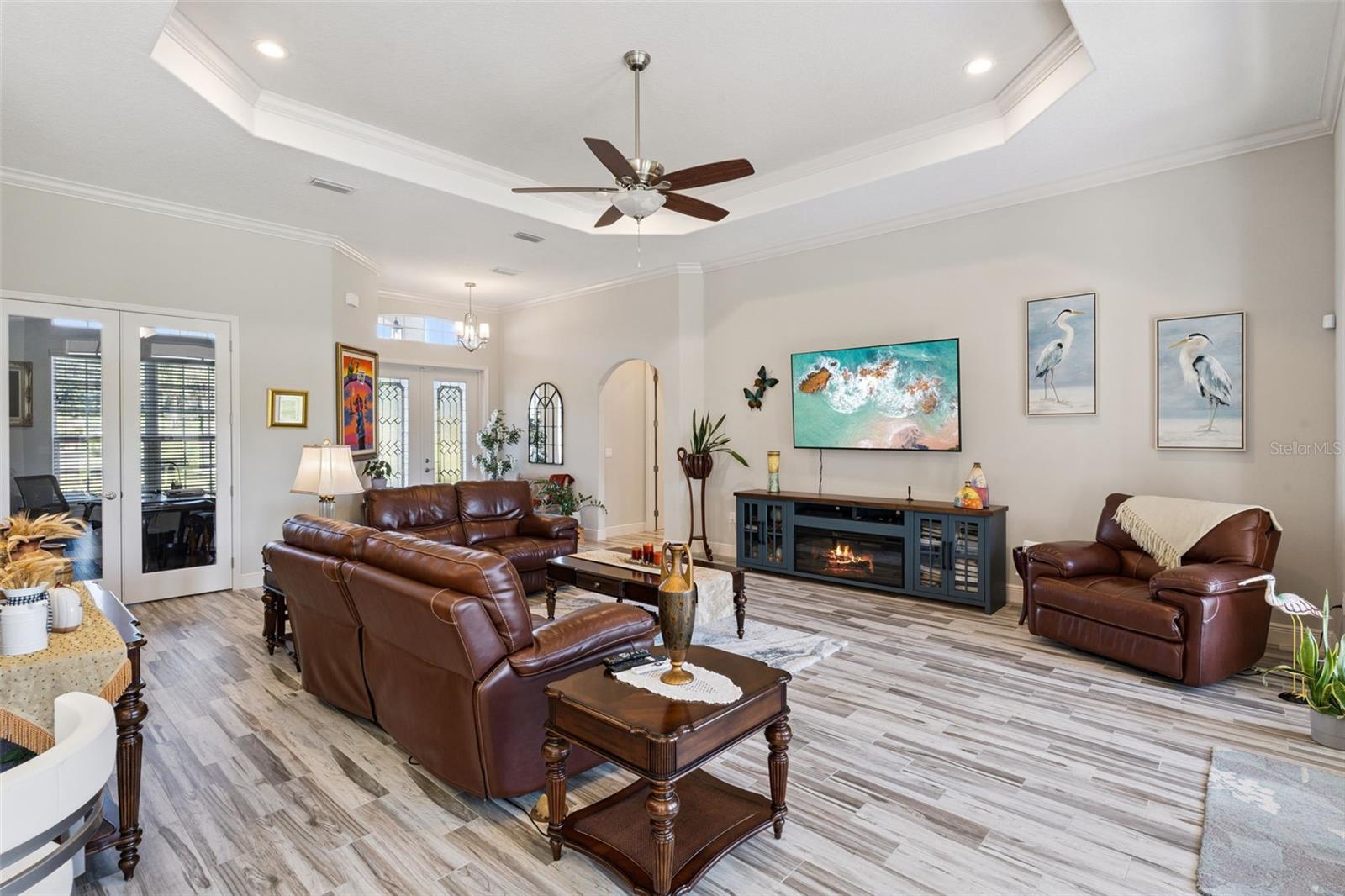Trey ceiling in family room with view of french doors that lead to private office